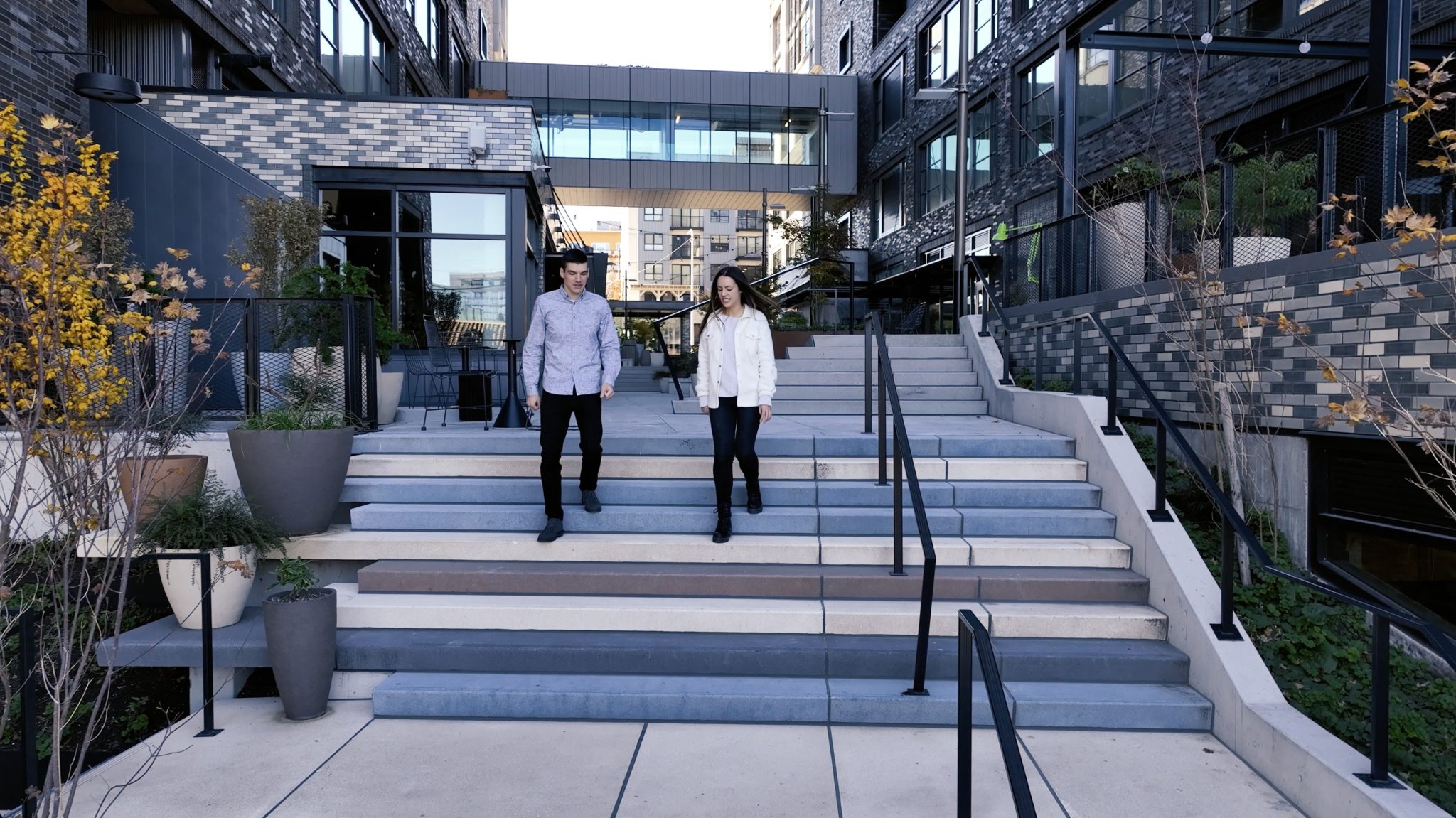 Two Dexter office workers walking down stairs